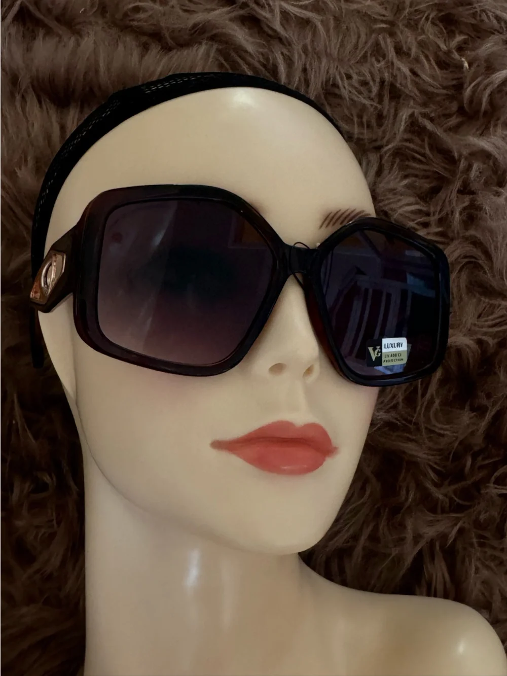 Futuristic sunglasses with large button detail on the sides